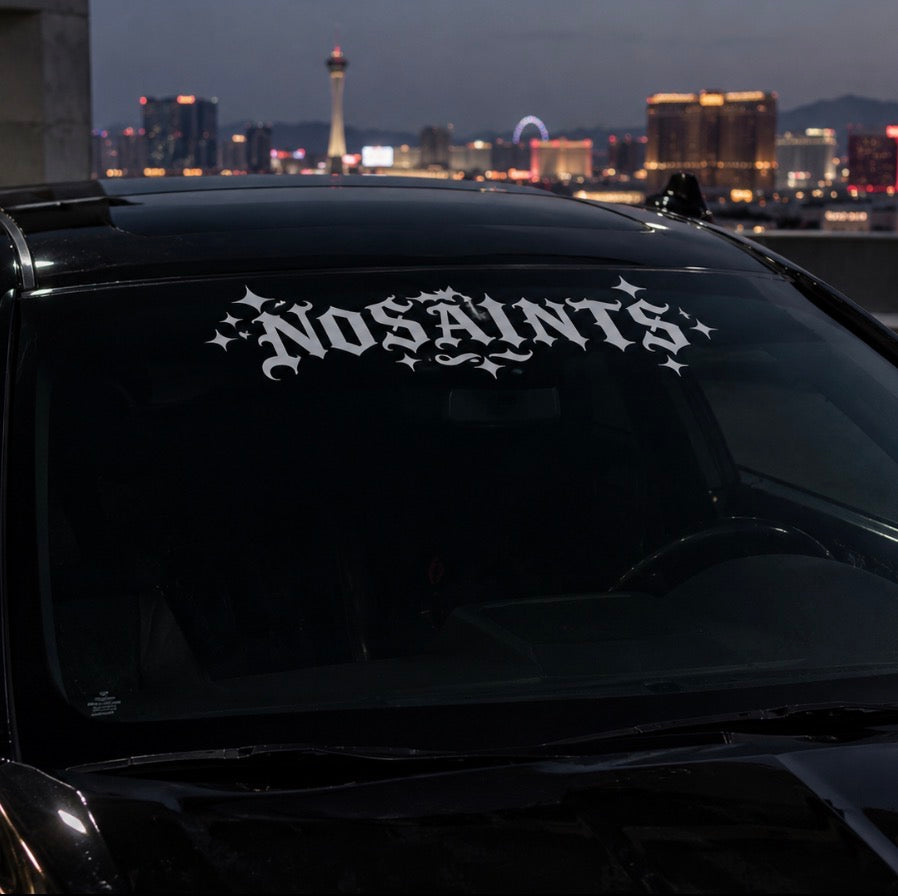 NOSAINTS windshield decal on car at night - chrome