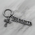 NOSAINTS Logo Keychain with cross charm on marble surface